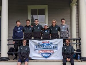 cross country team with NAIA flag