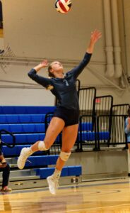 Girl jumping to hit a volleyball